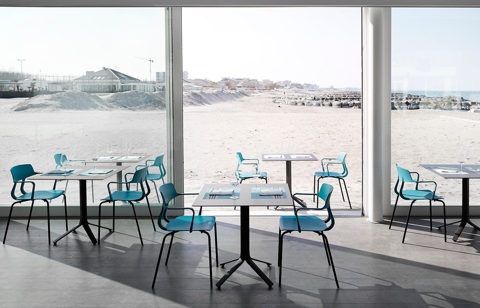 Sala de restaurante com cadeiras Snap e mesas de pé central